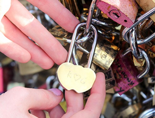 Engraved love locket on one of the Love Lock bridges in Paris