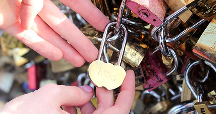 Engraved love locket on one of the Love Lock bridges in Paris