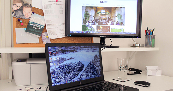 My office; laptop with a background image of Iceland and second monitor with Cripps Barn website